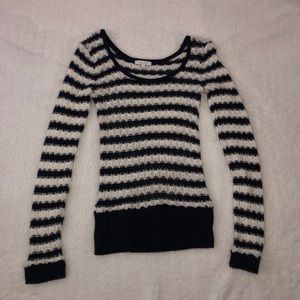 A women’s white and blue striped sweater